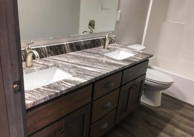 Wood bath cabinet vanity with custom natural stone granite countertop by Gordon Creek Granite of Hicksville, Ohio.